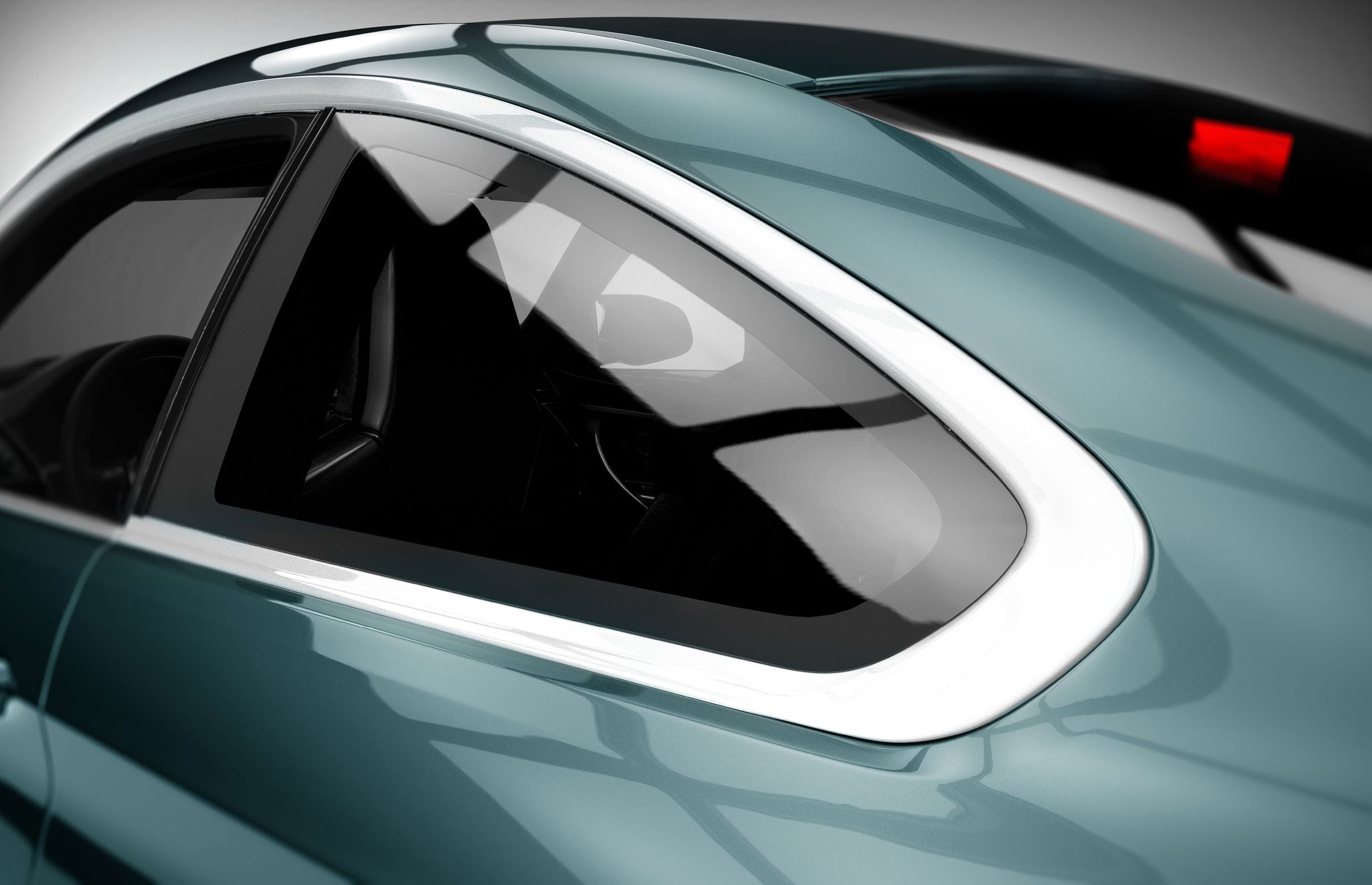 The rear window and roofline of a silver car